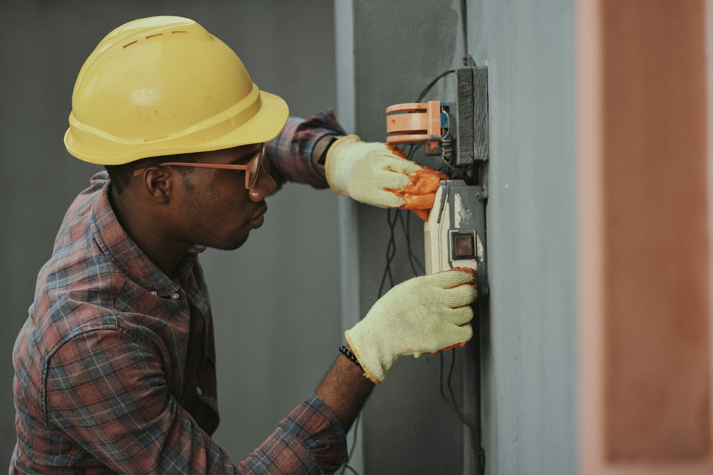 Home-service technician working inside a residential utility area